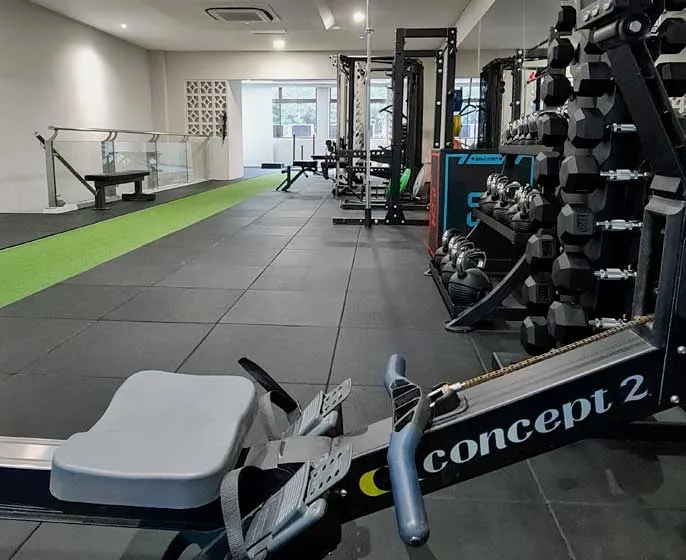 Turf lane, rower and free-weight area inside the studio
