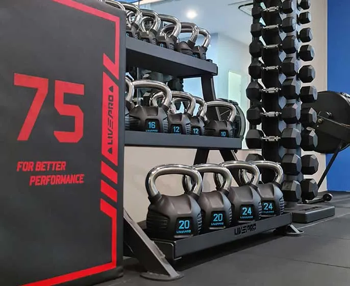 Kettlebells and dumbbells on the studio racks